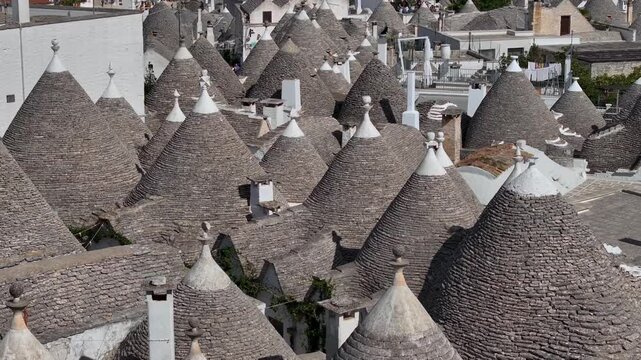 Traditional Trulli Rooftops, Aerial Shot of Unique Conical Roofed Houses of Alberobello in Puglia, Italy. Sunny Day.