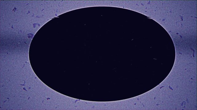 Abstract vintage film projector effect with a central dark oval vignette.