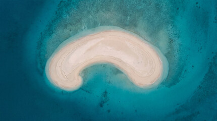Fototapeta premium Beautiful Aerial Drone Shot Of A Crescent Sandbar Emerging From Deep Turquoise Ocean Waters Stock