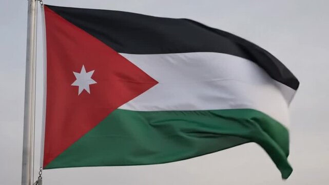 The national flag of the hashemite kingdom of jordan waving in the wind