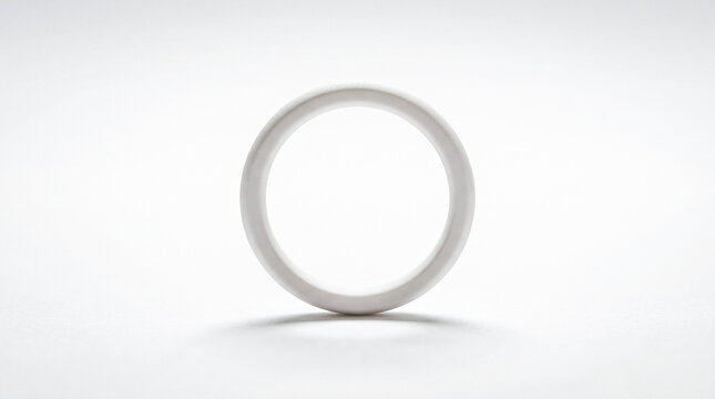 Minimalist white 3D ring object isolated on a clean white background with soft shadow