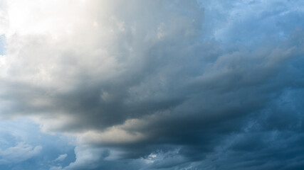 Fototapeta premium Dark rain cloud dramatic sky summer tropical thunder storm sky and fluffy black darkness cloud nearly raining cloudscape. Dark gray sky cloudy environment. Nimbus raincloud skyline climate background