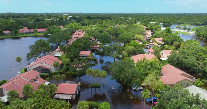 Flooding in Florida caused by tropical storm from hurricane rainfall. Suburb houses in residential community surrounded by flood waters. Aftermath of natural disaster