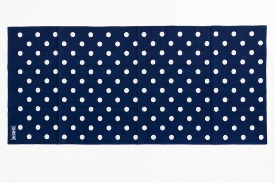 Traditional Japanese indigo polka dot cloth fully unfolded on white background.