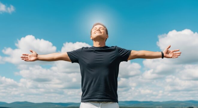 Man embracing freedom under a bright sunny sky with arms wide open