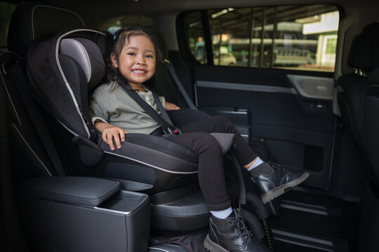 happy preschool child girl sitting in car seat, safety baby chair travelling