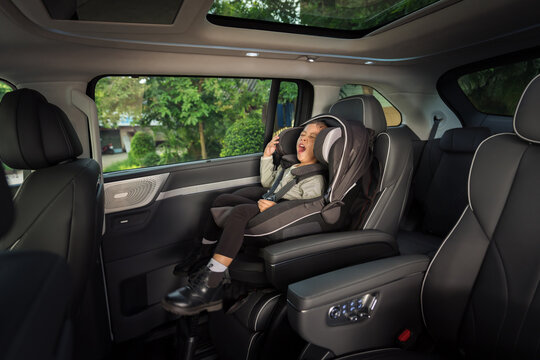 sleepy preschool child girl yawning while sitting in car seat, safety chair travelling