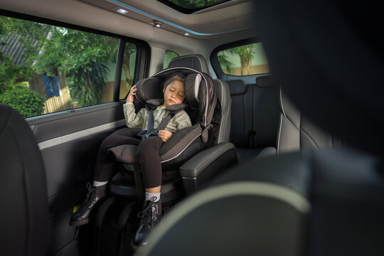 preschool child girl sitting and sleeping in car seat, safety baby chair travelling