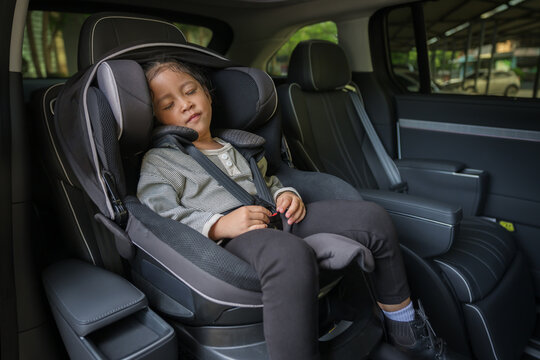 preschool child girl sitting and sleeping in car seat, safety baby chair travelling