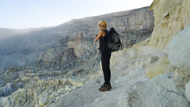 Female Hiker Exploring Ijen Crater Landscape in Banyuwangi, East Java, Indonesia.
