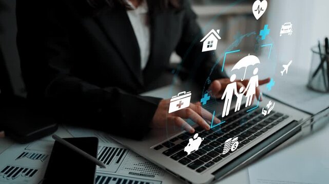 Business Professional Using Laptop with Health and Insurance Icons for Digital Strategy and Planning in Modern Office Environment. Entropy.