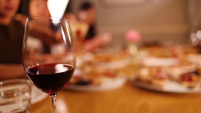 Close Up of Red Wine Glass at Italian Dinner Party