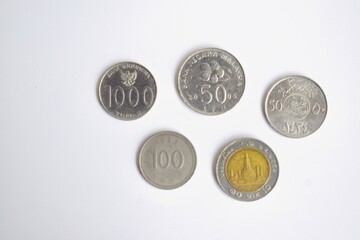 A collection of five different international coins, including Malaysian Sen, Indonesian Rupiah, and Thailand Baht, isolated on a clean white background. © Akram