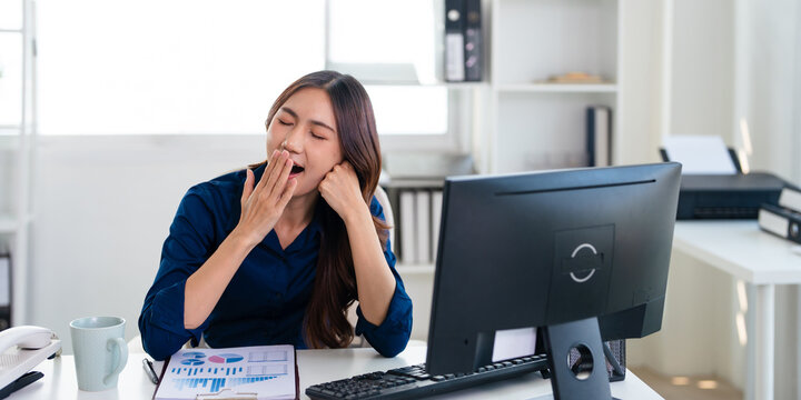 Tired exhausted business woman overworked business entrepreneur working laptop computer yawning at office workplace. sleepy bored lazy drowsy  yawn sleep.