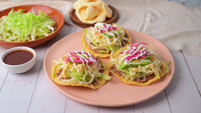 Authentic Mexican food, shredded chicken tostadas with fresh ingredients on a plate