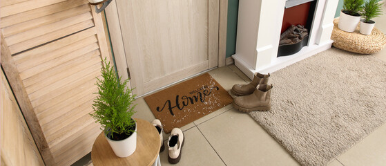 Obraz premium Interior of hallway with door, fireplace and winter shoes