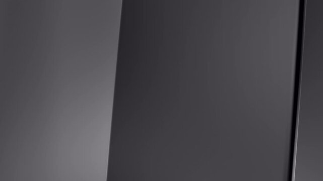 Elegant dark grey metallic sheets morphing smoothly with an industrial satin finish. Cinematic 4K abstract b-roll background texture for premium automotive, fashion, and luxury tech branding.