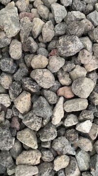 Close-up footage of crushed stones used as aggregate for construction, roadwork, drainage systems, and concrete production.