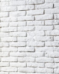 Fototapeta premium White painted brick wall with a rough textured surface and visible mortar lines in a horizontal brick pattern.