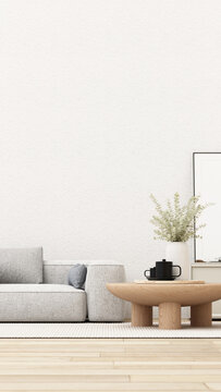 Modern neutral living room with a textured grey sofa, low oak coffee table, eucalyptus vase and blank framed poster.
