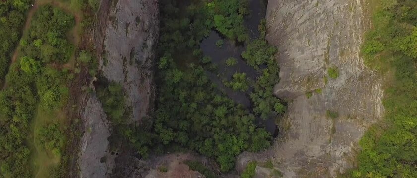 Top down aerial view of a deep rocky quarry