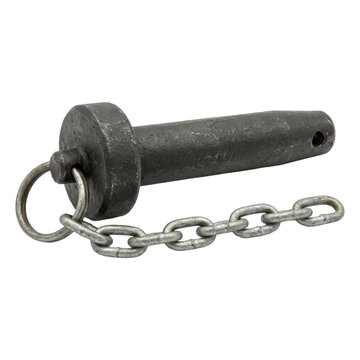 A dark, textured metal clevis pin with an attached chain lies on a transparent background. This industrial hardware component is isolated for clear focus on its rugged design.