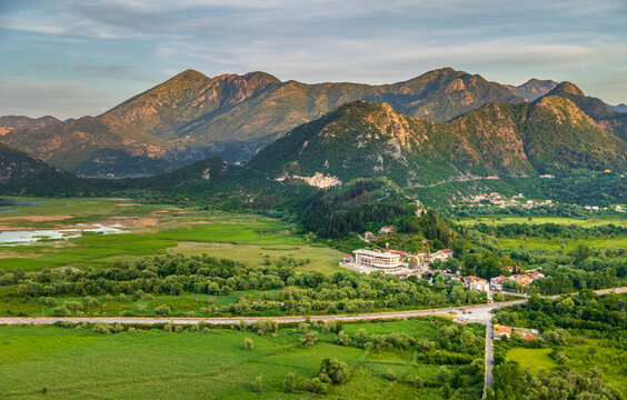 Aerial view of the historic town of Virpazar nestled in a lush green valley near Skadar Lake with rugged mountains in the background Virpazar, Bar Municipality, Montenegro.