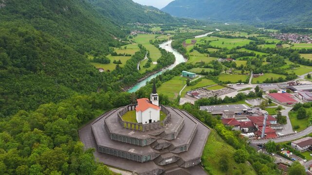 Kobarid Ossuary honors Isonzo Front history above Soca Valley in Slovenia, drone pull-back shot