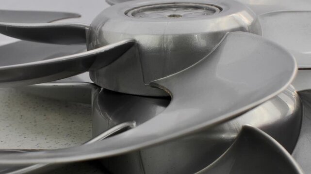 New fan impeller, disassembled into a technical composition, ready for assembly and use. Meticulous detail of newly manufactured fan impeller, disassembled for inspection and assembly.