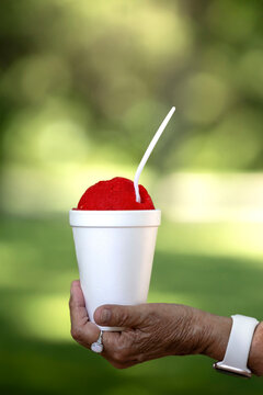 Woman holding a red snow cone