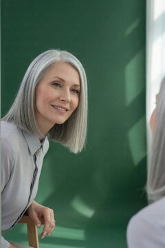 Silver white natural grey straight lob hair portrait of mature woman