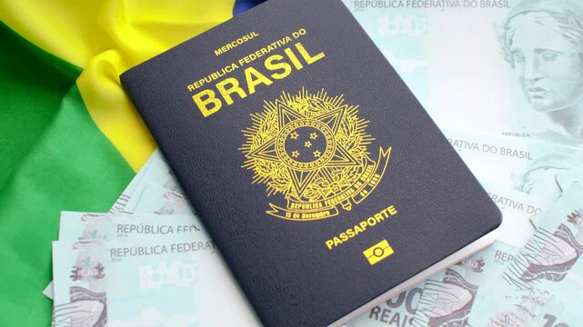 Version 1: Brazilian passport on the national flag and 100 real bills. Symbols of Brazil's identity and prosperity.