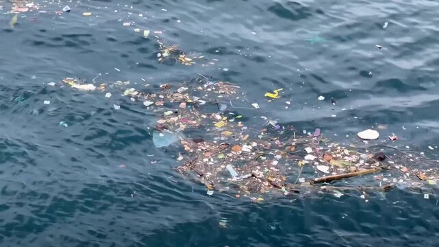 Plastic pollution and garbage floating in the ocean water