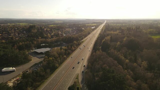 Aerial view of the M5 motorway with traffic flowing through the countryside of Gloucestershire, United Kingdom.