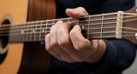 Obraz premium Close-up of a hand playing acoustic guitar, musical concept
