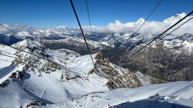 Cable car ride over snowy Swiss Alps mountains