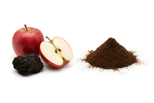 Fresh red apple with raw shilajit resin and brown extract powder