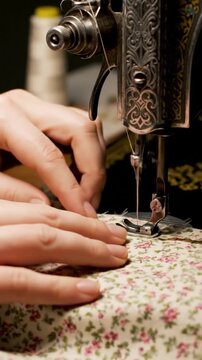 Skillful hands guide a vintage sewing machine with care