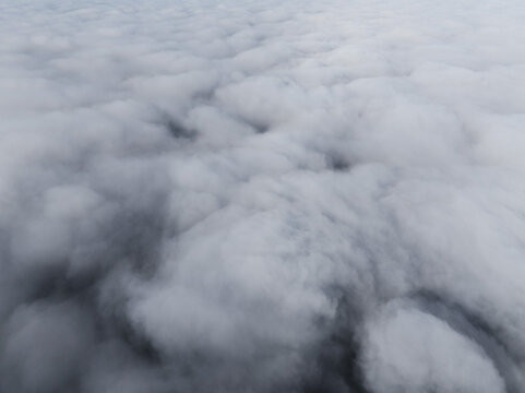 Aerial view of a dense layer of white clouds covering the sky over Latvia.