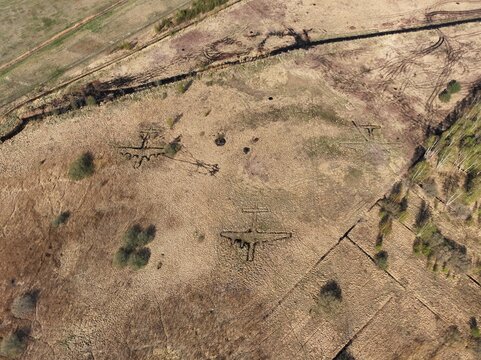 Aerial view of World War II decoy trenches shaped like aircraft outlines in a field near Liepaja Airport, Liepaja, Latvia.