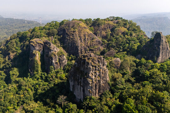 Aerial view of Ancient Volcano Nglanggeran, featuring massive volcanic rock formations surrounded by dense tropical forest in Kecamatan Patuk, Daerah Istimewa Yogya, Indonesia.