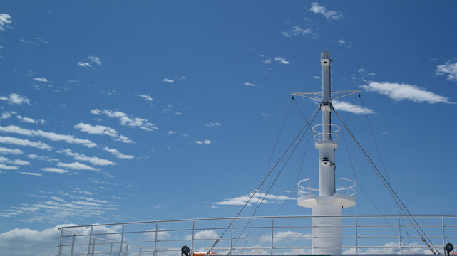 White mast of the Naoshima ferry under a beautiful sunny blue sky, Japan