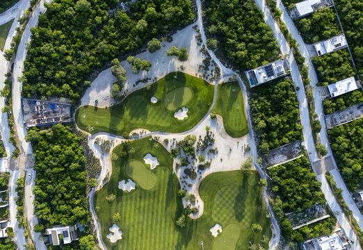 Aerial view of Provincia Golf Club featuring lush green fairways, sand bunkers, and surrounding tropical vegetation in Merida, Yucatan, Mexico.