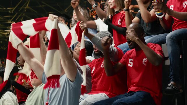 Ecstatic soccer fans throwing confetti and celebrating big win after last minute goal, winning the world championship trophy, happy crowd cheering and jumping after final whistle, fan euphoria.
