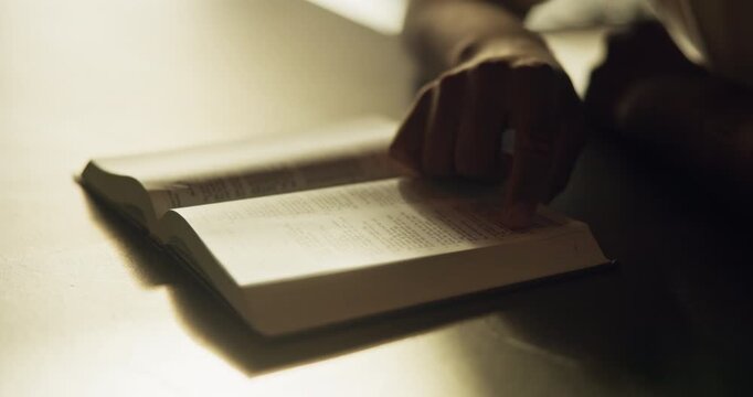 Hands, reading and person with bible for worship, guidance and verse for spiritual understanding. Holy, book and pointing for learning scripture, religious education and sermon preparation with faith