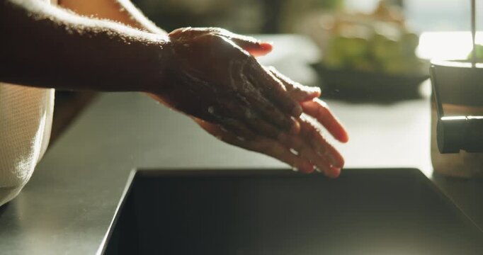 Hygiene, soap and person washing hands in home for health maintenance, germ removal or wellness. Man, kitchen sink and cleaning skin for bacteria prevention, safety and self care with disinfection