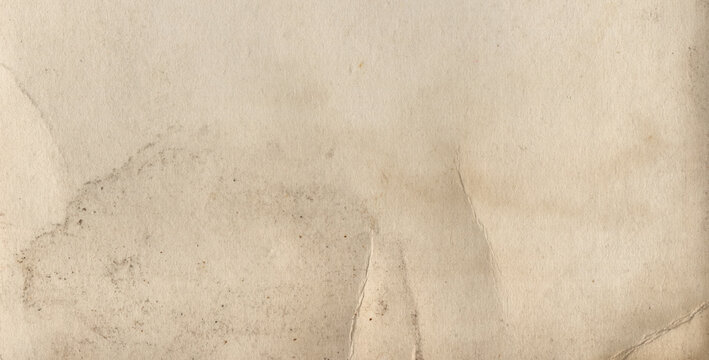 Aged paper texture with faint imprint traces, slight discoloration and visible crease marks in panoramic format.