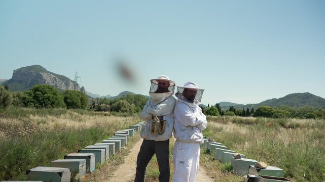 Professional beekeepers posing at their honey bee farm