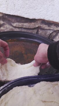 Frying dough in oil person POV