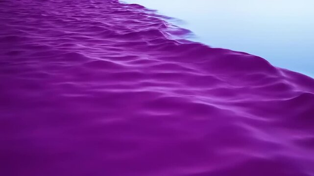 Purple sand meets blue water edge.